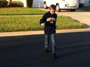 boy gliding in Heelys