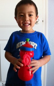 boy holds red sports bottle