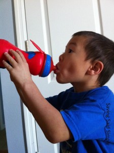 boy drinks from sports bottle