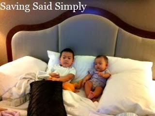 Kids laying in hotel bed