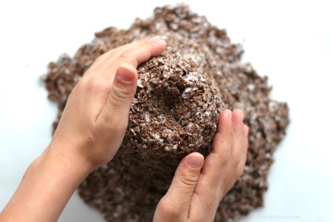 Dinosaur Sensory Bin with Edible Volcano | Fun kids activity and snack in one! DIY Dinosaur Sensory Bin + Edible Volcano Recipe with Cocoa & Fruity Pebbles - Sensory play idea for kids. This preschool sensory play idea is non toxic and edible for kids - #Recipe #SensoryPlay #Preschool #KidsActivities 