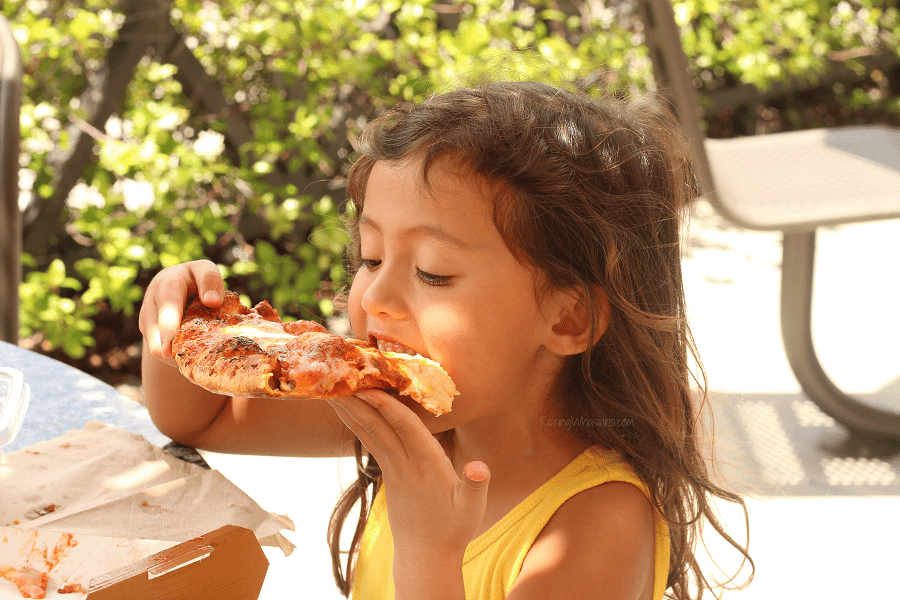 Pizza lunch date ideas Pizza lunch date ideas | Girl eating slice of pizza